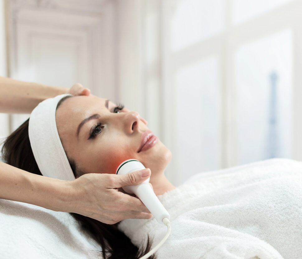 woman have facial laser treatment in beauty spa, paris in background